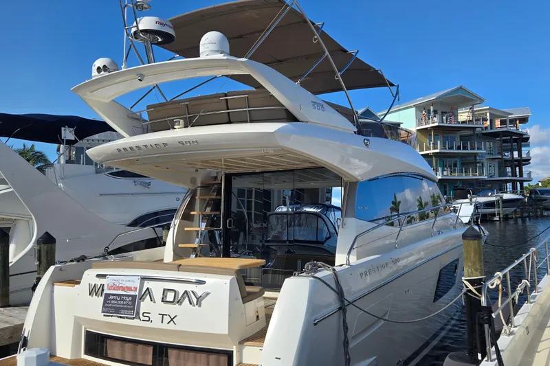 What A Day Yacht Photos Pics Luxury 2013 Prestige 500 yacht docked at marina, clear blue sky, waterfront homes.