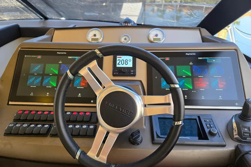 What A Day Yacht Photos Pics Steering wheel and dashboard of a 2013 Prestige 500 yacht with digital displays.