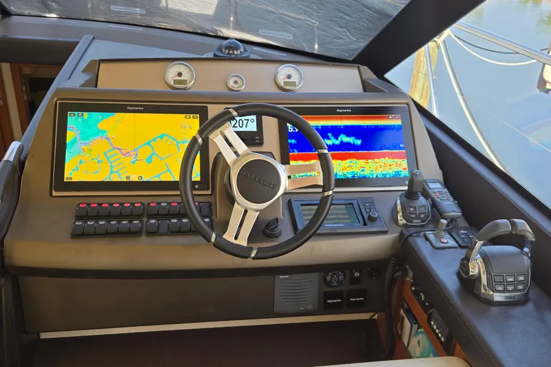 What A Day Yacht Photos Pics Cockpit of 2013 Prestige 500 yacht with navigation screens and steering wheel.