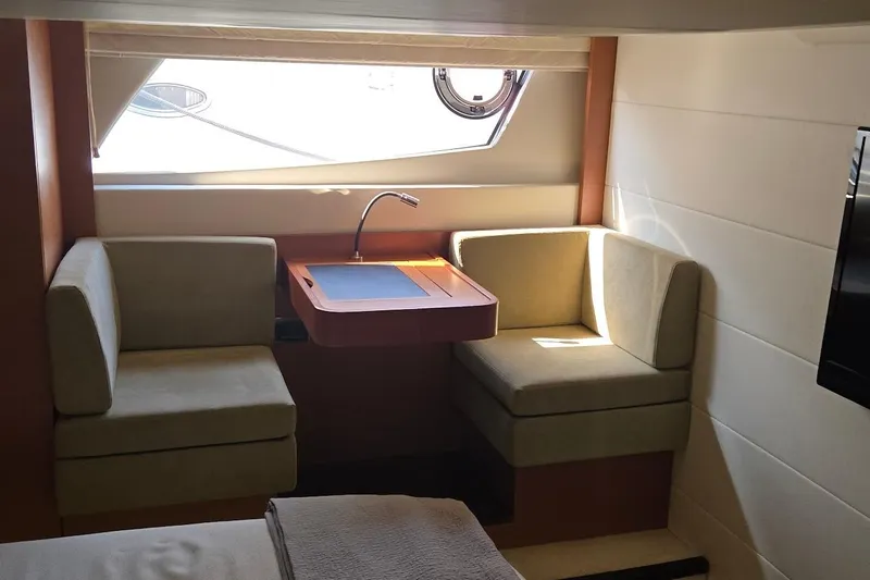 What A Day Yacht Photos Pics Luxurious interior of 2013 Prestige 500 yacht with seating and desk area.