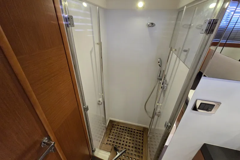 What A Day Yacht Photos Pics Shower area in 2013 Prestige 500 yacht with glass doors and wooden floor.