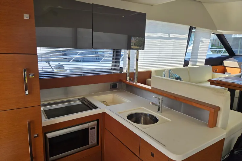 What A Day Yacht Photos Pics Modern kitchen interior on a 2013 Prestige 500 yacht, featuring sleek cabinetry and appliances.