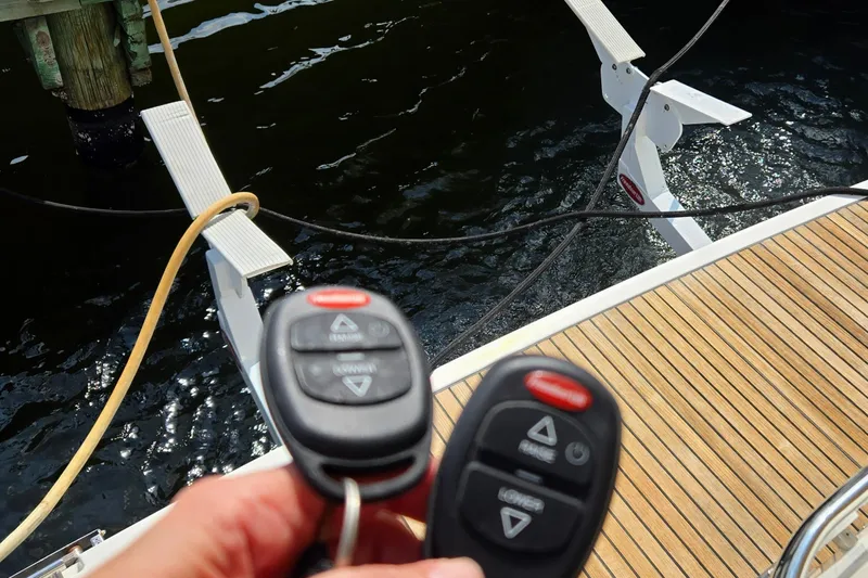 What A Day Yacht Photos Pics Remote controls on a 2013 Prestige 500 yacht near a wooden deck and water.