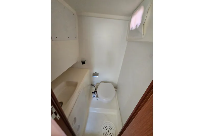 What A Day Yacht Photos Pics Compact bathroom in 2013 Prestige 500 yacht, featuring toilet and sink.