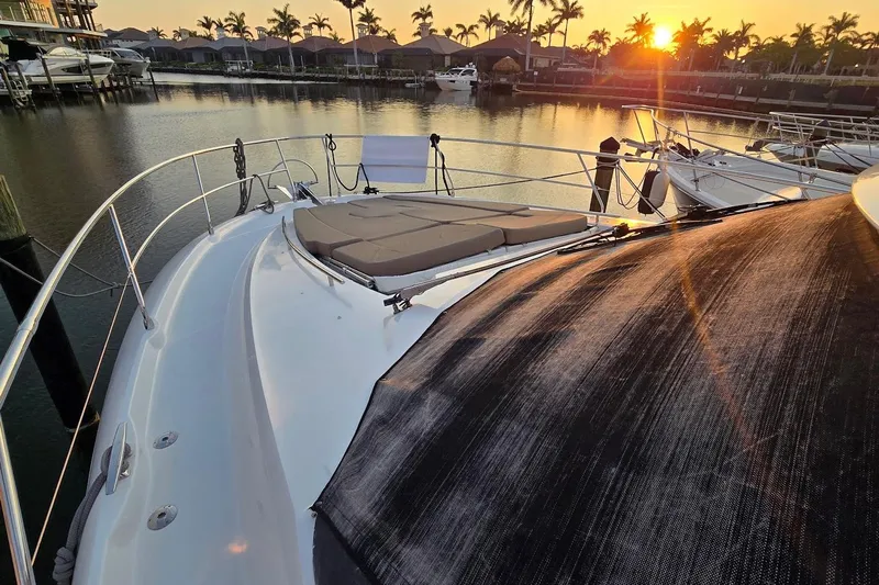 What A Day Yacht Photos Pics 2013 Prestige 500 yacht at sunset in a marina with palm trees.