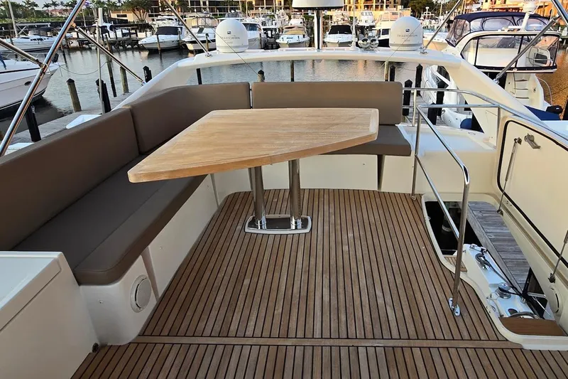 What A Day Yacht Photos Pics Luxurious 2013 Prestige 500 yacht deck with seating and wooden table at marina.
