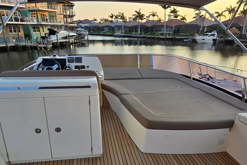 What A Day Yacht Photos Pics Prestige 500 yacht deck, 2013 model, with seating area overlooking a serene waterfront.