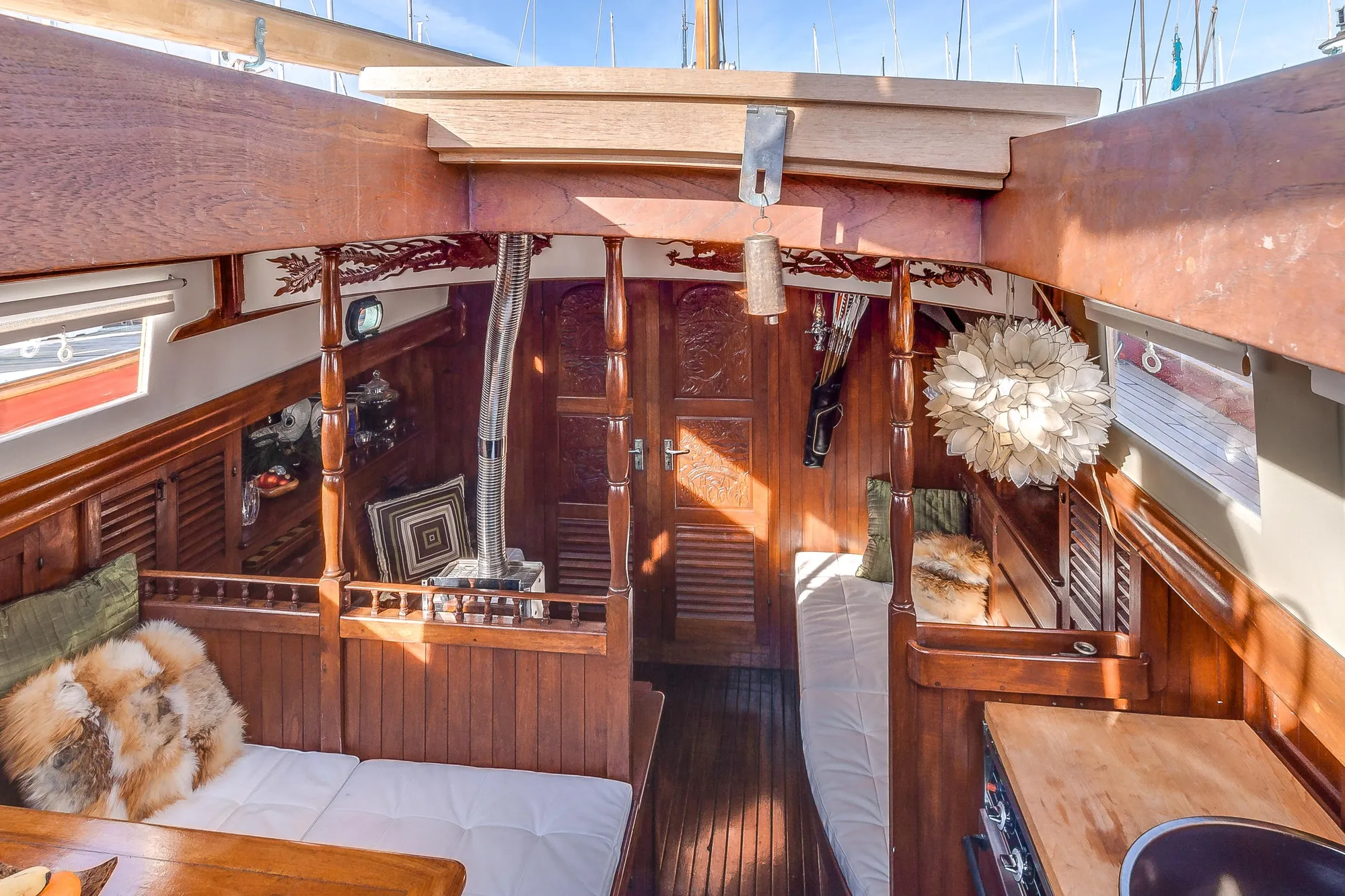 Interior of a 1971 Formosa 41 sailboat with wooden decor and cozy seating.