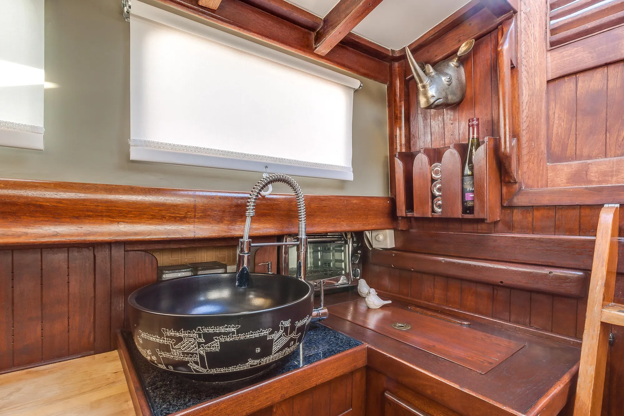 Vintage 1971 Formosa 41 yacht interior with wooden cabinetry and decorative sink.