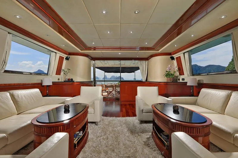 Demarest Yacht Photos Pics Luxurious interior of a 2002 Falcon 106 yacht with elegant seating and panoramic windows.