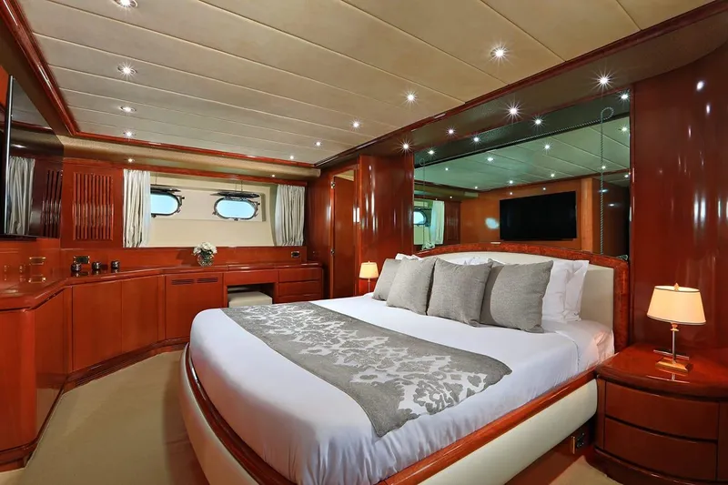Demarest Yacht Photos Pics Luxurious bedroom interior on 2002 Falcon 106 yacht with elegant wood finishes and modern amenities.