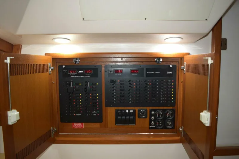 Never Again VII Yacht Photos Pics Electrical control panel inside 2006 Cabo 35 Express boat, featuring switches and gauges.