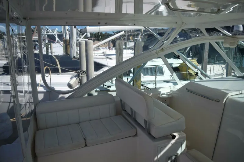 Never Again VII Yacht Photos Pics 2006 Cabo 35 Express yacht interior with white seating and marina view.