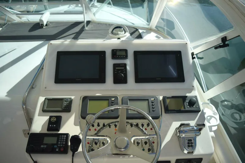 Never Again VII Yacht Photos Pics Helm of 2006 Cabo 35 Express boat with navigation screens and controls.