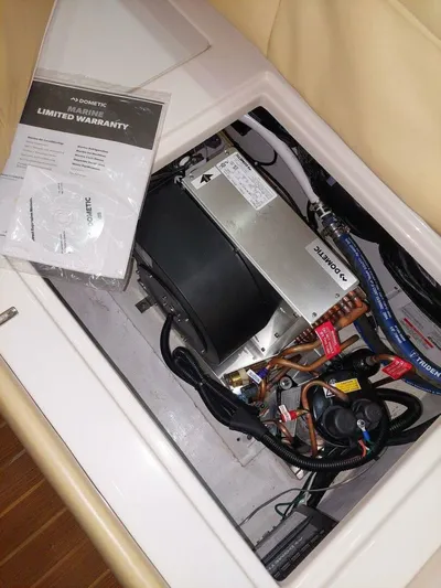 Never Again VII Yacht Photos Pics Engine compartment of a 2006 Cabo 35 Express with Dometic marine equipment and warranty documents.