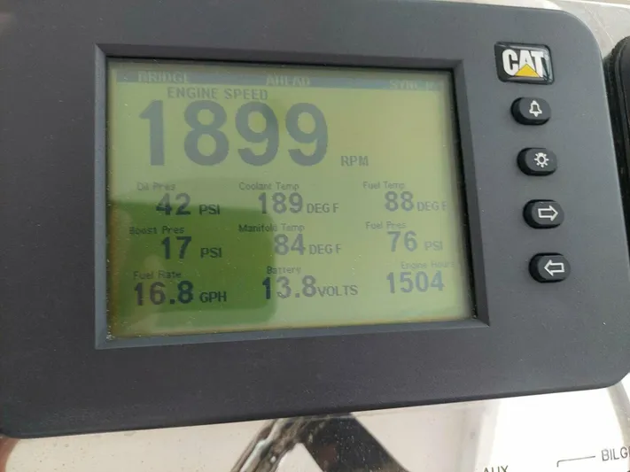 Never Again VII Yacht Photos Pics CAT engine display showing RPM, oil pressure, fuel rate, and temperature readings on a 2006 Cabo 35 Express.