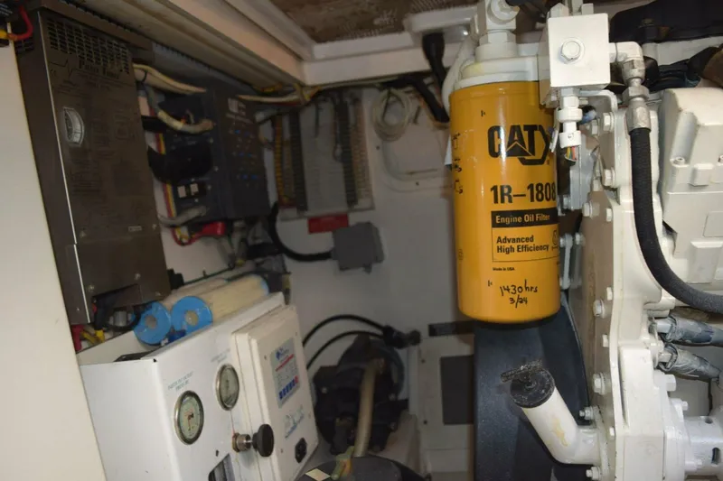 Never Again VII Yacht Photos Pics Engine room of 2006 Cabo 35 Express with CAT oil filter and control panels.