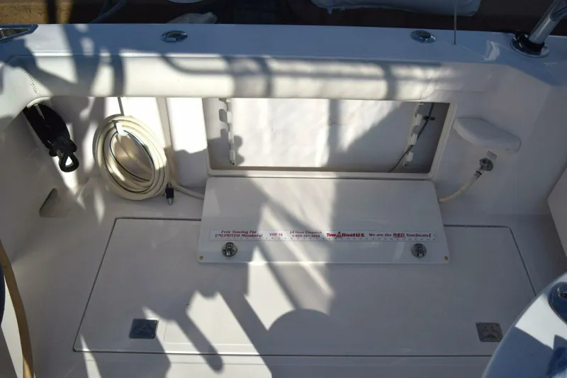 Never Again VII Yacht Photos Pics 2006 Cabo 35 Express boat deck with storage compartment and coiled hose.