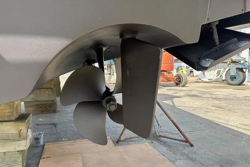 Never Again VII Yacht Photos Pics Propeller and rudder of a 2006 Cabo 35 Express boat in a shipyard.