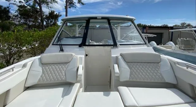 Wcn 51988 325dc Wht Mer350 Yacht Photos Pics 2024 World Cat 325 DC boat with white cushioned seating and windshield.