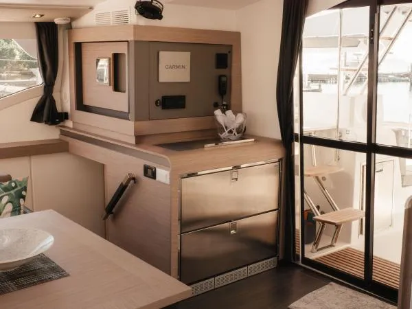 Sea The World Yacht Photos Pics Modern interior of 2023 Fountaine Pajot Elba 45 yacht with sleek kitchen design.