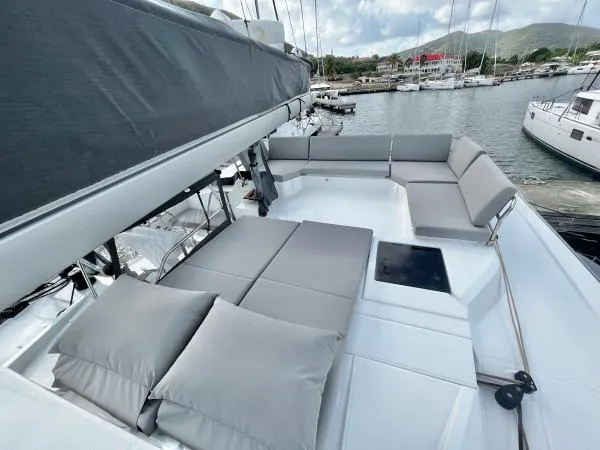 Sea The World Yacht Photos Pics 2023 Fountaine Pajot Elba 45 yacht with spacious deck and comfortable seating in marina.