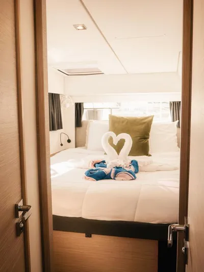 Sea The World Yacht Photos Pics Luxurious cabin interior of 2023 Fountaine Pajot Elba 45 with elegant bedding and decor.