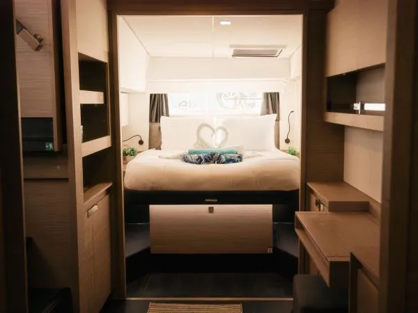 Sea The World Yacht Photos Pics Luxurious interior of 2023 Fountaine Pajot Elba 45 catamaran with elegant bedroom design.