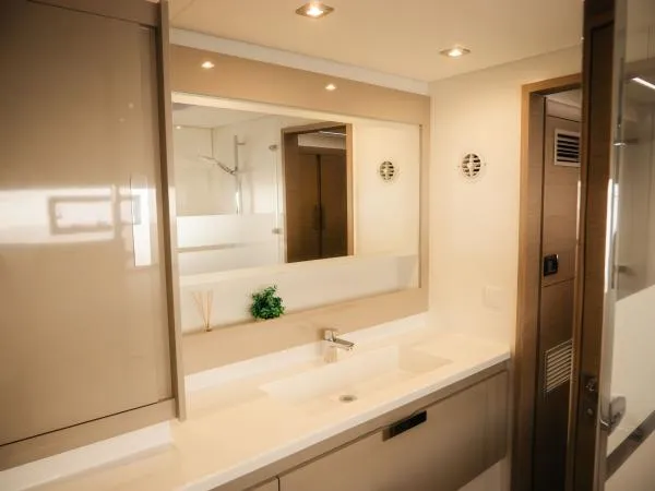 Sea The World Yacht Photos Pics Modern bathroom interior on 2023 Fountaine Pajot Elba 45 yacht, featuring sleek design and elegant fixtures.