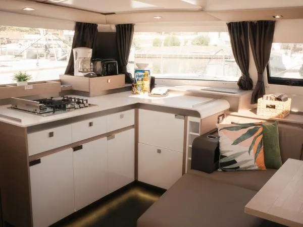 Sea The World Yacht Photos Pics Modern kitchen interior of 2023 Fountaine Pajot Elba 45 catamaran with stylish decor.