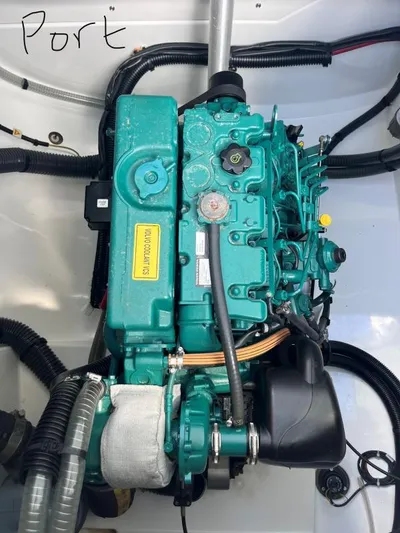 Sea The World Yacht Photos Pics Engine compartment of 2023 Fountaine Pajot Elba 45 catamaran, featuring a green marine engine.