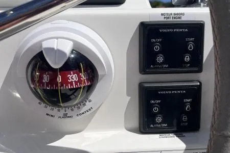 Sea The World Yacht Photos Pics Control panel of 2023 Fountaine Pajot Elba 45 with compass and Volvo Penta engine controls.