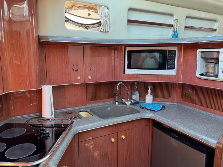  Yacht Photos Pics 1998 Sea Ray 420 Aft Cabin kitchen with microwave, stove, and sink.