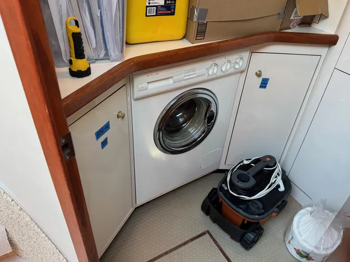  Yacht Photos Pics Laundry area in 1998 Sea Ray 420 Aft Cabin with washer and cleaning supplies.