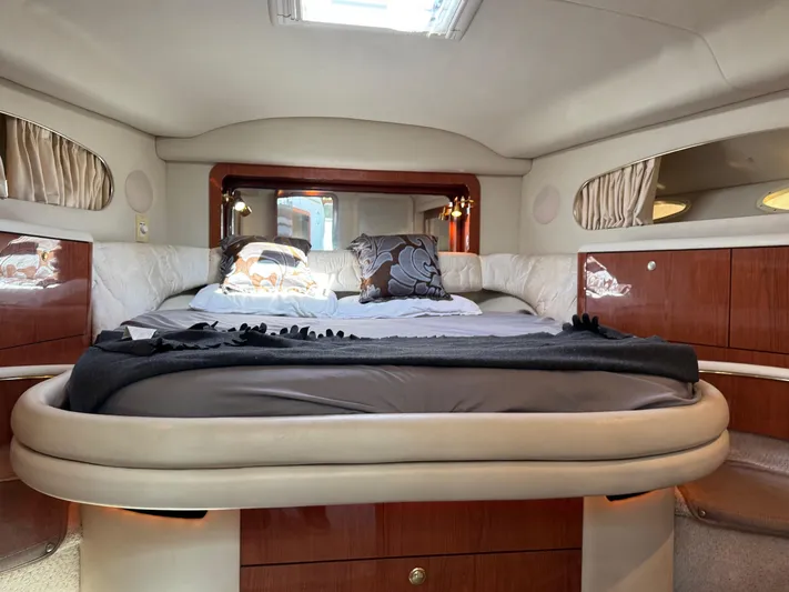  Yacht Photos Pics Luxurious 1998 Sea Ray 420 Aft Cabin bedroom with elegant wood accents and plush bedding.