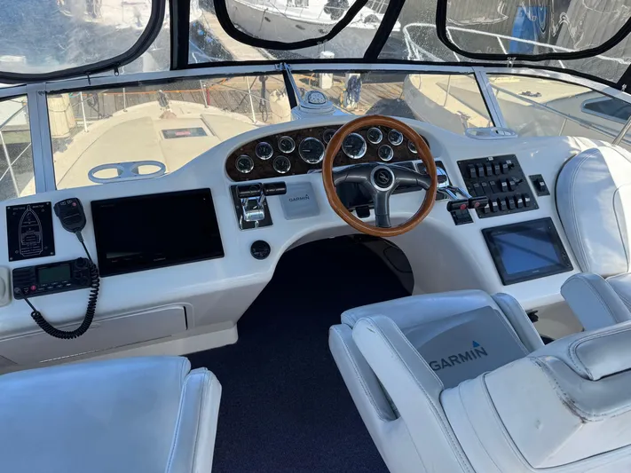  Yacht Photos Pics Cockpit of 1998 Sea Ray 420 Aft Cabin with modern navigation equipment and wooden steering wheel.