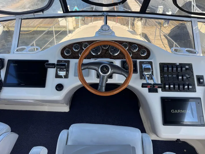  Yacht Photos Pics 1998 Sea Ray 420 Aft Cabin helm with wooden steering wheel and Garmin navigation system.