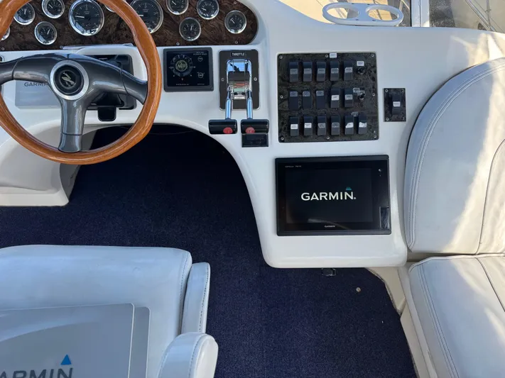  Yacht Photos Pics 1998 Sea Ray 420 Aft Cabin helm with Garmin navigation and wood-accented steering wheel.