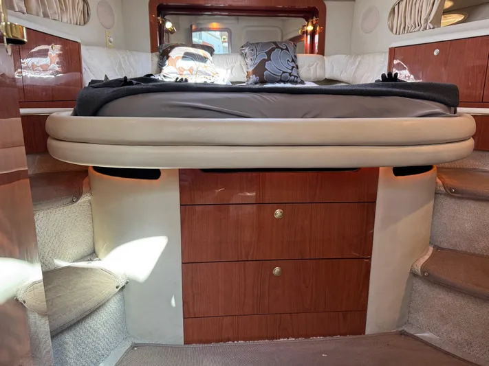  Yacht Photos Pics 1998 Sea Ray 420 Aft Cabin interior with bed, wooden cabinetry, and carpeted steps.