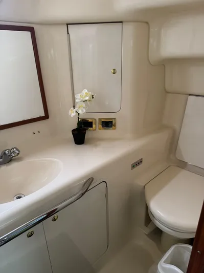 Yacht Photos Pics 1998 Sea Ray 420 Aft Cabin bathroom with sink, mirror, and toilet.