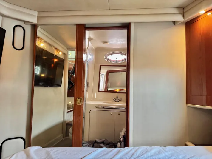  Yacht Photos Pics Interior of 1998 Sea Ray 420 Aft Cabin yacht, featuring a cozy bedroom and bathroom.