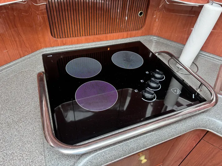  Yacht Photos Pics Stovetop in 1998 Sea Ray 420 Aft Cabin yacht kitchen with wooden cabinetry.