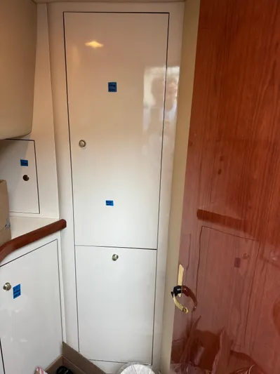  Yacht Photos Pics Interior of 1998 Sea Ray 420 Aft Cabin with white cabinetry and wooden door.