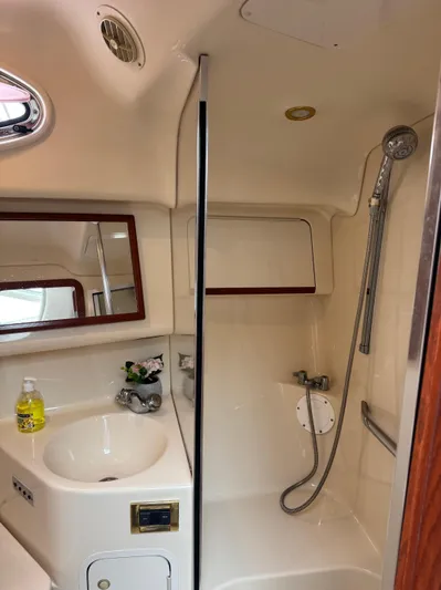  Yacht Photos Pics 1998 Sea Ray 420 Aft Cabin bathroom with sink, mirror, and shower.