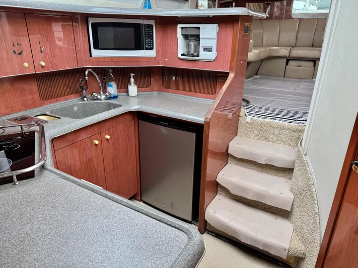  Yacht Photos Pics 1998 Sea Ray 420 Aft Cabin interior with kitchen, microwave, and stairs to seating area.