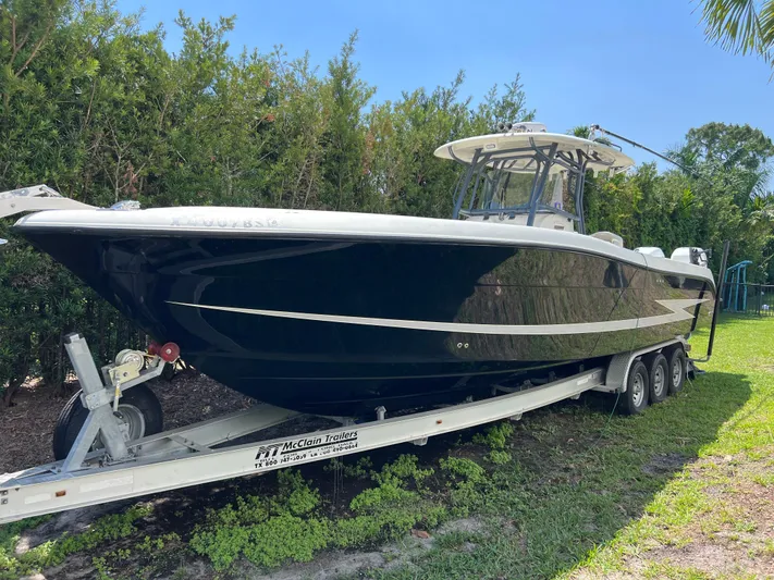  Yacht Photos Pics 2012 Hydra-Sports 3400 CC boat on trailer, parked outdoors, surrounded by greenery.