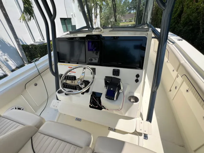  Yacht Photos Pics 2012 Hydra-Sports 3400 CC boat cockpit with steering wheel and navigation equipment.