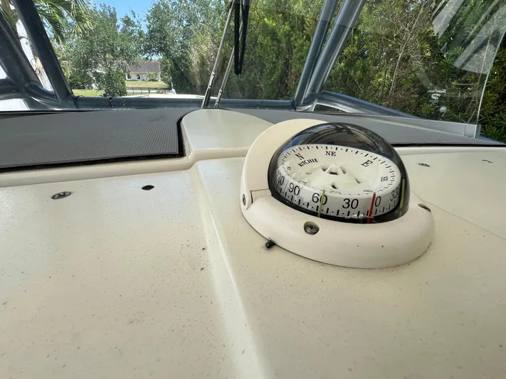  Yacht Photos Pics 2012 Hydra-Sports 3400 CC boat compass on dashboard, surrounded by trees.
