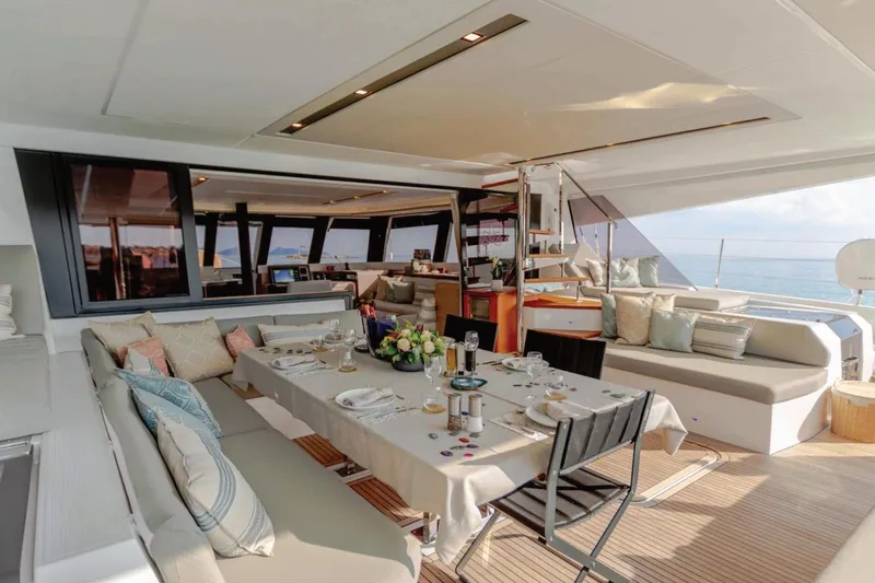  Yacht Photos Pics Luxurious 2021 Fountaine Pajot Samana 59 yacht interior with elegant dining setup.