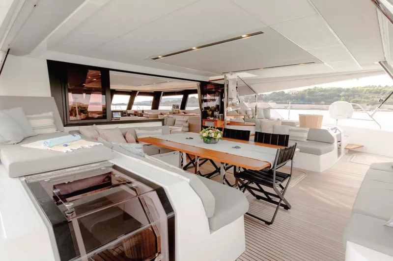 Yacht Photos Pics Luxurious 2021 Fountaine Pajot Samana 59 yacht interior with elegant seating and dining area.